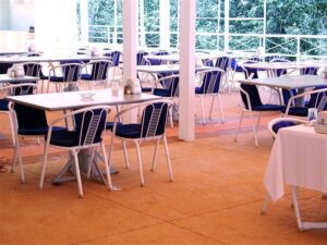 Outdoor café with empty tables and chairs.