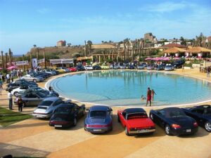 Sports cars surrounding a large circular fountain