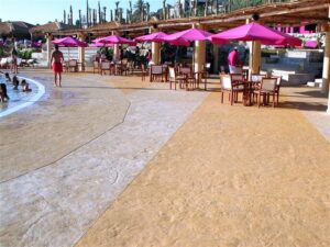 Poolside seating with pink umbrellas