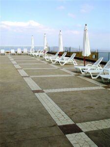 Empty poolside with loungers and umbrellas