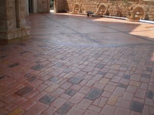 Sunlit stone courtyard with patterned floor