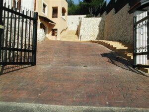 Gated driveway with stone walls