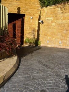 Curved driveway with stone wall