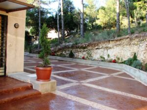 Stone patio beside lush greenery