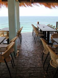 Oceanfront dining with wicker chairs