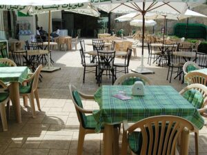 Sunlit outdoor dining area with chairs