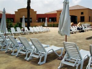 White sun loungers by poolside