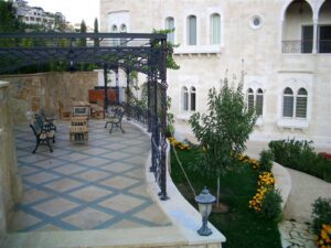 Elegant patio with iron canopy and benches