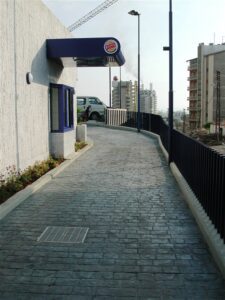 Narrow paved path beside building