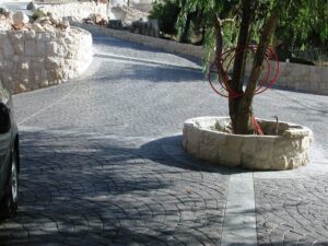 Curved stone driveway with tree planter