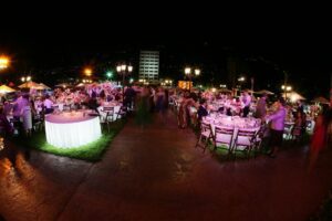Outdoor night event with round tables