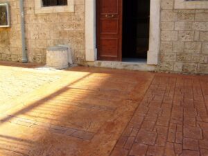 Rustic courtyard entrance with shadow patterns