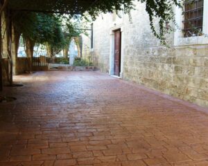 Stone courtyard with leafy archway