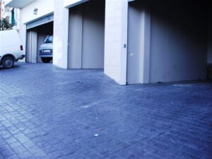 Paved driveway leading to garages