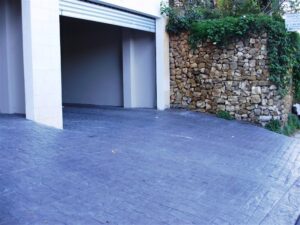 Open garage next to stone wall
