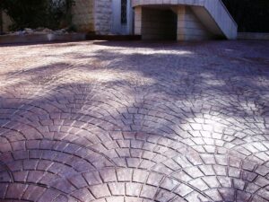 Sunlit textured concrete driveway surface
