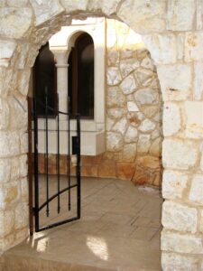 Open gate leading to stone courtyard