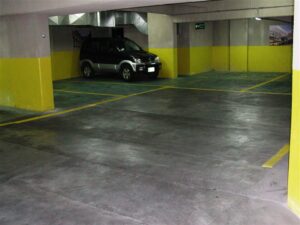 Spacious indoor parking area with single vehicle.