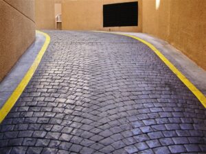 Winding brick road between buildings.