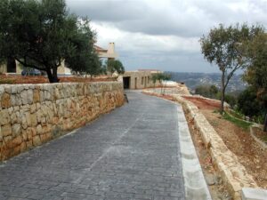 Residential driveway with stone retaining wall