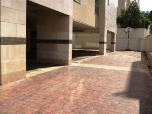 Empty driveway beside apartment building