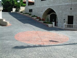 Stone driveway with red circular pattern
