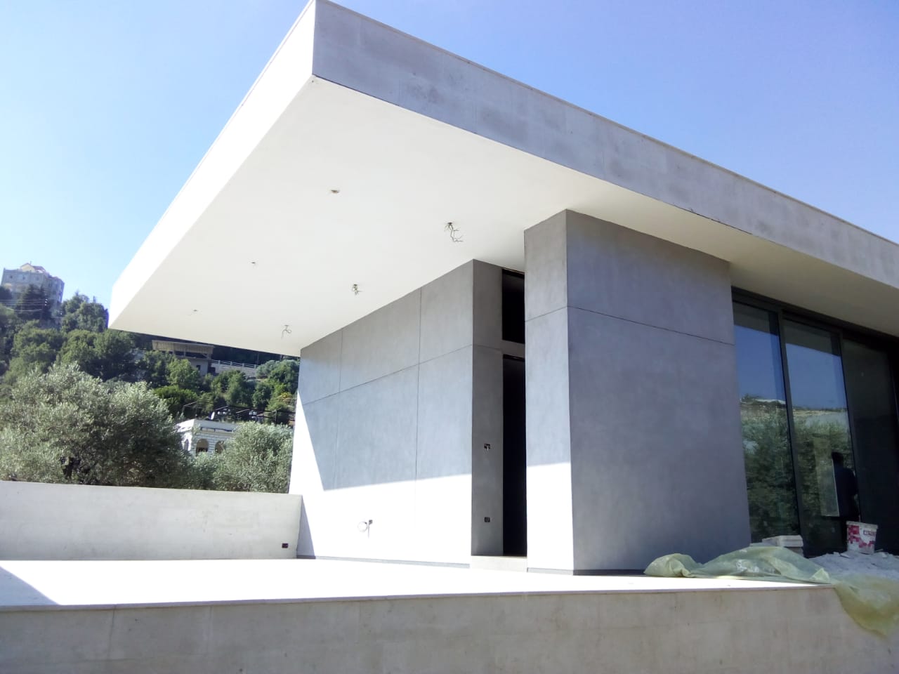 Sleek concrete building surrounded by greenery