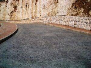 Paved road with stone wall