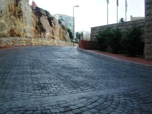 Curved cobblestone street with hillside view
