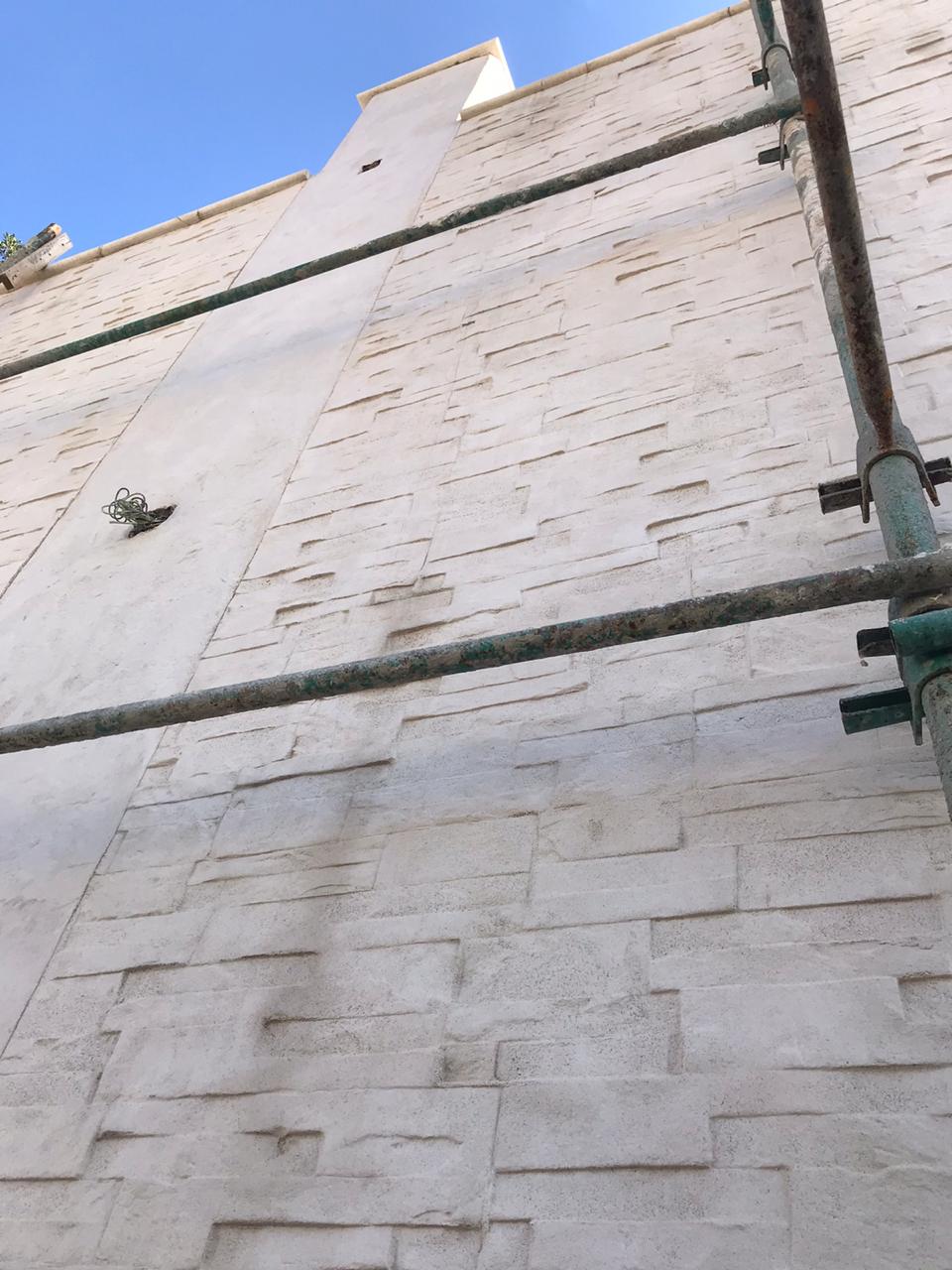 Scaffolding beside tall stone building