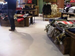 Clothing store interior with wooden tables