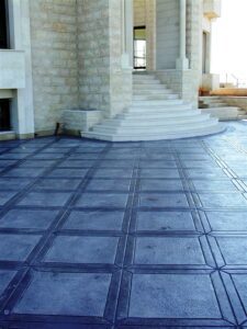 Geometric patterned stone flooring outside building