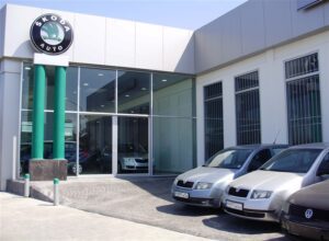 Car dealership entrance with parked vehicles