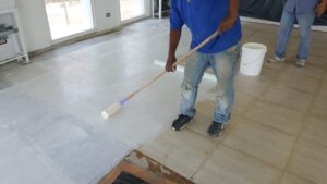 Floor painting in progress with roller