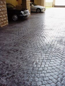 Two cars on cobblestone surface