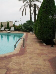 Poolside with palm trees and loungers