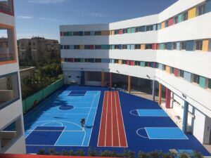 Modern school building with blue courts