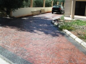 Red brick driveway with parked car