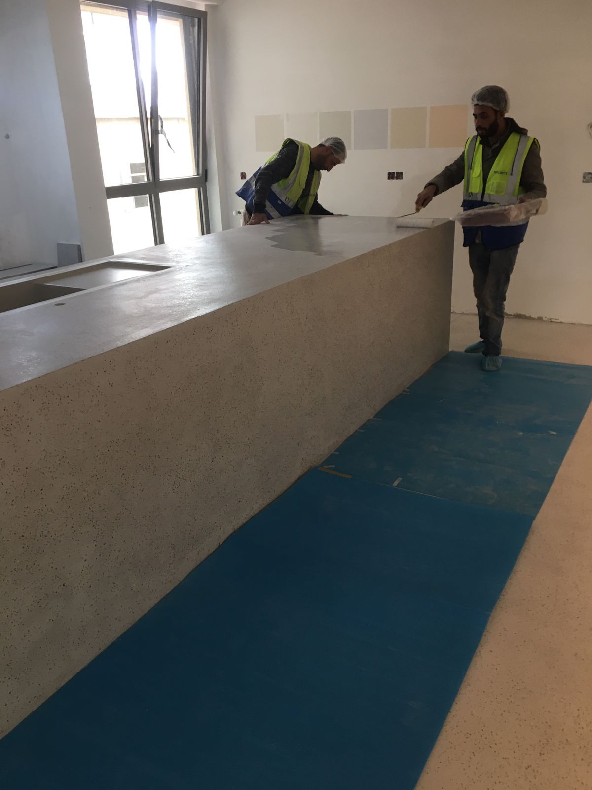 Construction workers handling countertop installation