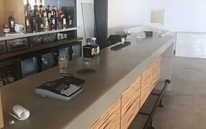 Modern bar counter with bottles and equipment