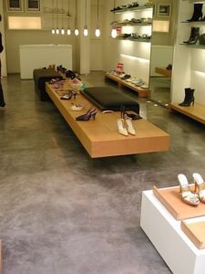 Display of various shoes on wooden shelves