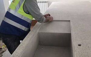 Person polishing concrete kitchen counter