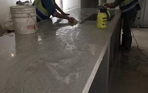 Workers polishing a concrete countertop