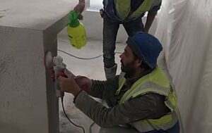 Construction workers using tools on site