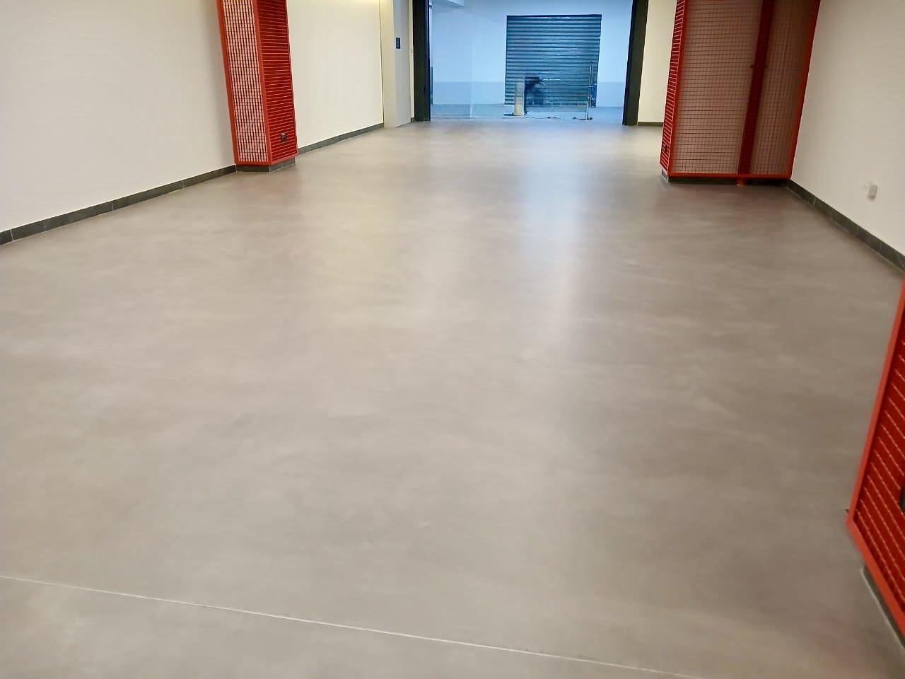 Grey microtopping floor in a commercial lobby corridor, Lebanon