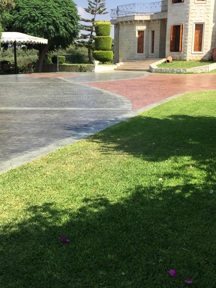 Grey and terracotta stamped concrete driveway at a villa in Lebanon