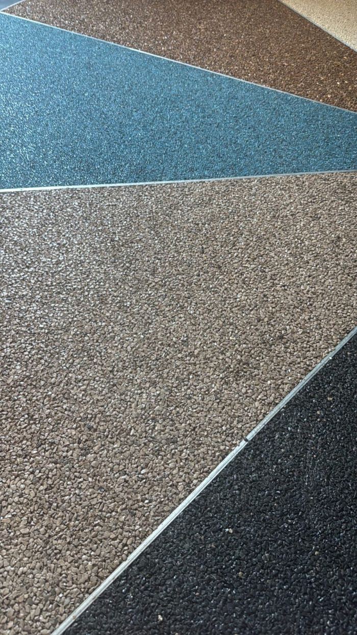 StoneTop resin-bound stone carpet panels in blue, brown, beige and black with aluminium divider strips, Lebanon